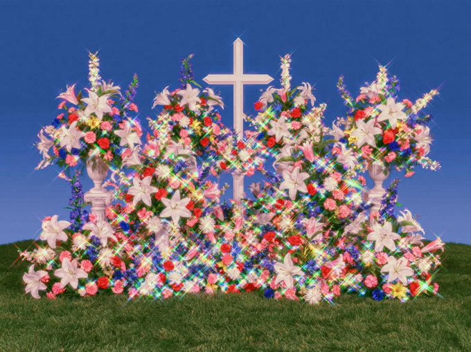 A vibrant, sparkling digital display features a white cross surrounded by elaborate floral arrangements of lilies, roses, and other blossoms on a grassy hill against a blue sky.