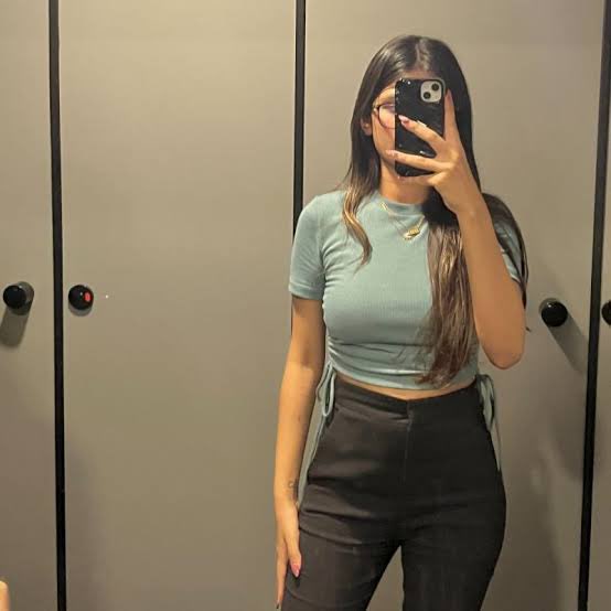 A woman with long brown hair takes a mirror selfie in a fitting room, wearing a sage green fitted short-sleeve crop top and black pants while holding a phone with a circular pop socket.

The image appears to be a personal mirror selfie shared alongside a post celebrating her progress in the River (RIVER) crypto community, where she earned 274 points to climb to 23rd rank with 12,411 total points—just a few spots away from the top 20 as the season wraps up in 3 days.