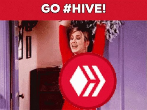 The image features a woman with her arms raised, wearing a red shirt that matches the color of the "Go #hive!" sign displayed below her. The background includes a purple door and a brown dresser.