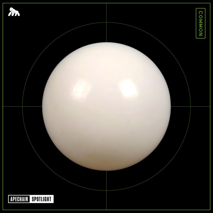 A white sphere is centered on a black background with green crosshairs, featuring the labels 'APECHAIN SPOTLIGHT' and 'COMMON' along with a small animal logo in the corner.