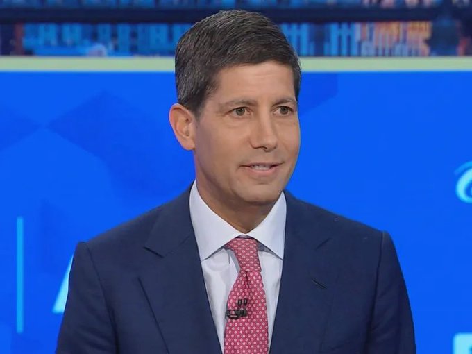 A CNN news anchor in a navy suit and pink tie appears to be reporting, aligning with a post claiming the Fed will inject $8.633 billion into the market next week, though no such ticker or text is visible in the image itself.