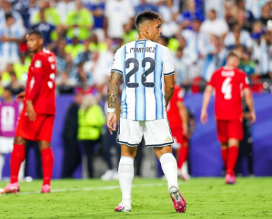 Argentine soccer player Lautaro Martínez, wearing jersey number 22, stands on the field with his back to the camera during a match.