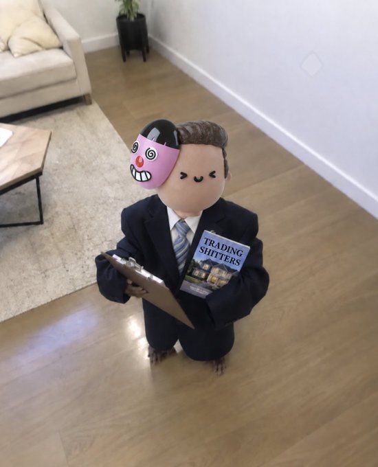 The image shows a plush figure of a businessman with a split face—one side a smiling clown and the other a stern look—holding a clipboard and a book titled "Trading Shitters," symbolizing the duality of someone trying to appear serious in trading while clowning their way through consistent losses. The caption humorously captures the post's sentiment about "wale" stubbornly refusing to get help or insider tips, instead opting to publicly struggle with five-figure trading losses for entertainment value.