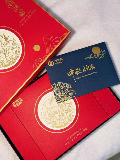 Red and navy mooncake gift boxes featuring gold lotus illustrations and Chinese calligraphy celebrate the Mid-Autumn Festival, with text reading "CoinMeta" and "Mid-Autumn Festival" alongside greetings to the FuGui Village community.
