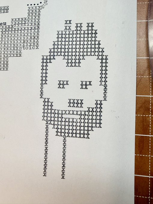 A hand-drawn cross-stitch or pixel art pattern on paper using X marks, depicting a stick figure with a beard and hood, with partial text 'beu' and 'ST01CX' visible at the top.