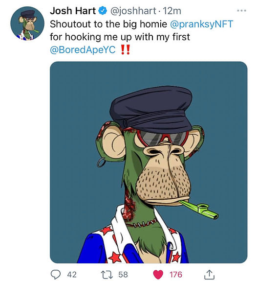 The image features a cartoon monkey wearing sunglasses, a hat, and a jacket with stars on it. The monkey appears to be smoking a pipe while standing against a blue background. The caption of the image reads "JOSH HART WAS A BORED APE*". This means that Josh Hart is being compared to a bored-apocalyptic character in the post.