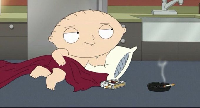 Stewie Griffin lounges contentedly in a red blanket near an ashtray with a burning cigarette and a discarded cigarette pack, smirking with relaxed satisfaction.

The image pairs with the post to suggest a calm, unbothered confidence when reaching out to @RobinhoodCrypto—as if casually puffing away without a care in the world.