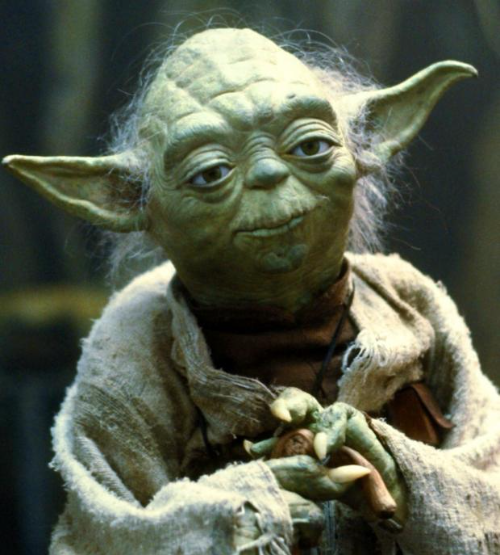 The image features a green alien character from Star Wars with a beard wearing a robe. The character appears to be holding something, possibly a toy or a weapon, while standing against a dark background. The caption below the image provides information about the series of threads that discuss the key choices made in the Star Wars universe over the past few years.