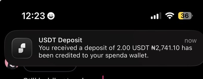 A iPhone notification showing a USDT deposit of 2.00 (₦2,741.10) credited to a Spenda wallet, confirming the user's successful transfer from Foxigrow to MySpenda.