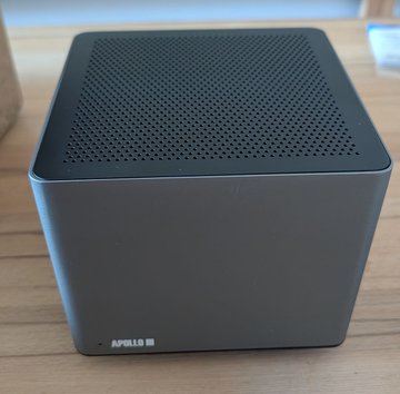 The image shows a black cube-shaped Apollo II device with a perforated mesh top and the text "APOLLO II" on the front corner, sitting on a wooden surface. This represents the culmination of 10 years and 5 generations of product development, marking the final refined form of the Apollo line as referenced in the post.