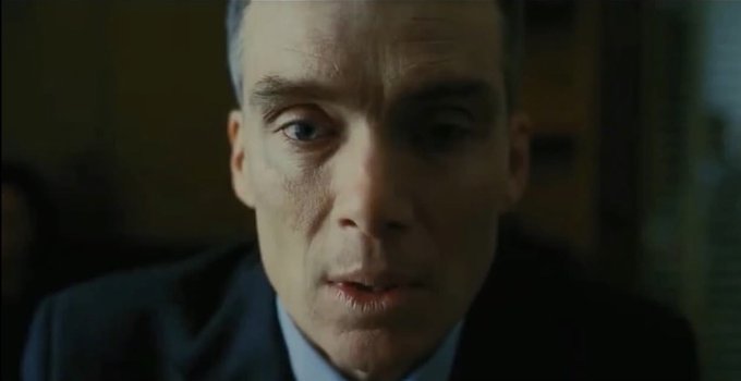 A close-up shot of a stern-faced man in a dark suit and tie, his expression serious and intense as he appears to be speaking. The accompanying caption about "The 'F' in Crypto" humorously juxtaposes the somber, concerned look on his face with the playful sentiment about cryptocurrency.