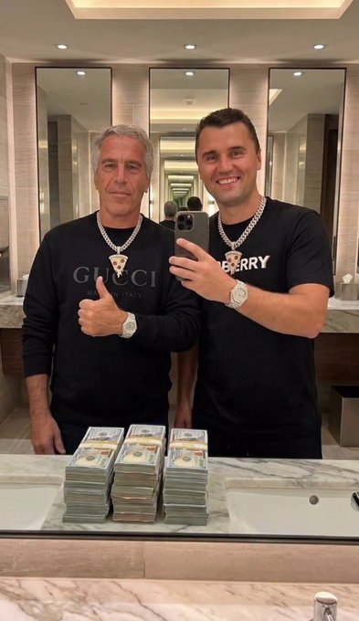 iced tea and a pizza are present on the counter, with two men standing behind it, one wearing a black sweatshirt with "gucci" printed on it and another wearing a black t-shirt with "eberry" written on it.