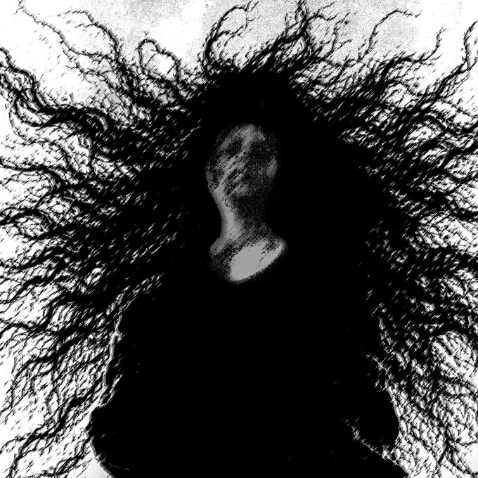 A black and white abstract image showing a dark, textured silhouette radiating outward like tangled branches or roots.