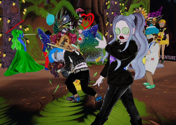 A screenshot from a 3D virtual environment (likely VRChat) featuring an anime-style avatar with long silver hair and cucumber eye patches in the foreground, with other colorful avatars in the background.