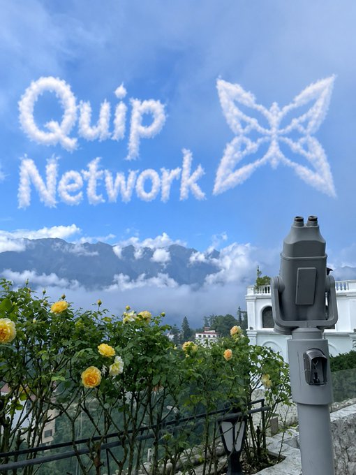 The image features a poster with the text "QUIP NETWORK" written on it, which appears to be a promotional piece for a job board or marketplace related to computing. The background of the poster shows a beautiful view of mountains under a blue sky filled with clouds. There is also a telescope in the scene, suggesting that this platform might cater to those interested in astronomy and space exploration.
