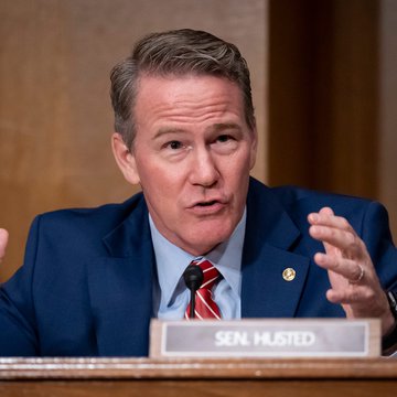 Senator Jon Husted, identified by a nameplate reading "SEN. HUSTED," is shown gesturing while speaking, visually reinforcing the post's message about his support for clear digital asset regulations and the need for congressional action.