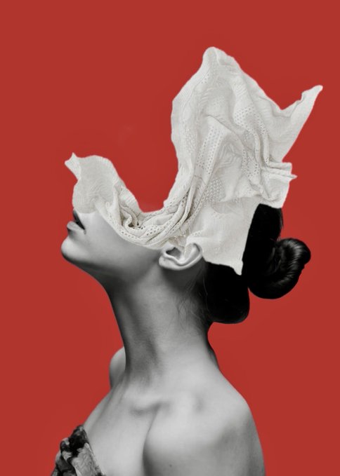 An artistic photo of a person tilting their head back, with white fabric billowing upward over their face against a red background.