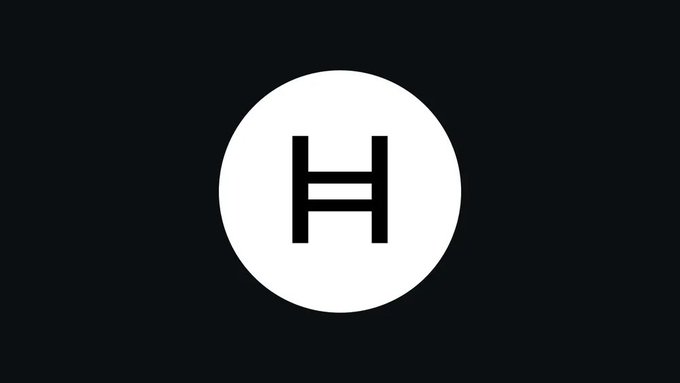 A minimalist logo featuring a white circle with a black stylized 'H' inside it, set against a dark background.