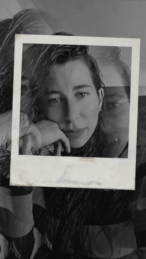 A black and white photo showing a close-up of a woman's face within a Polaroid frame overlay, with translucent reflections of her face in the background.