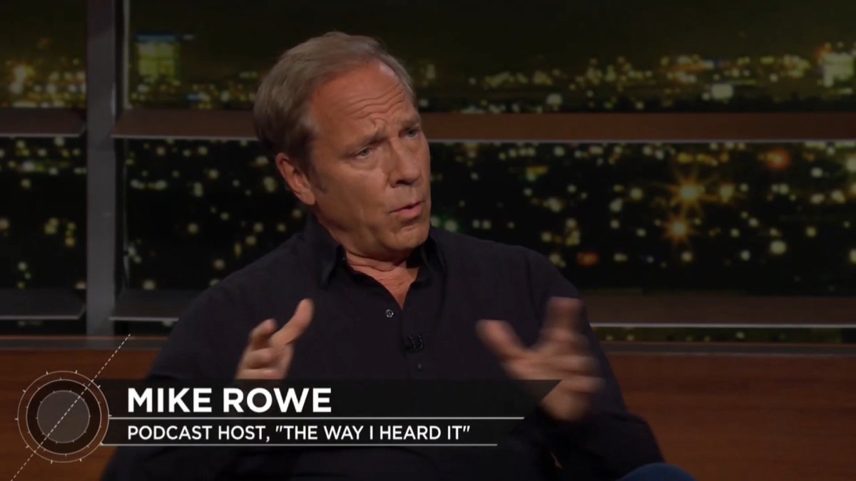 Mike Rowe, podcast host of "The Way I Heard It," is shown gesturing mid-conversation during what appears to be a television interview, with a nighttime city skyline visible in the background. The image relates to the post suggesting that this interview segment is being shared online and is likely to fuel ongoing media discussion.
