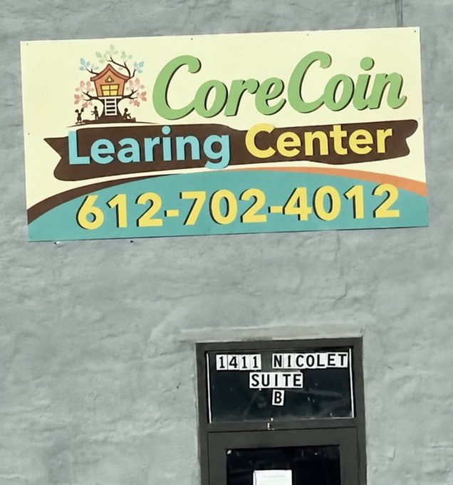 A business sign for 'CoreCoin Learing Center' with the phone number '612-702-4012', mounted above a door labeled '1411 NICOLET SUITE B'.
