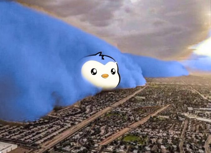 A giant cartoon penguin with a cute, round face emerges from fluffy blue clouds hovering over an aerial view of a sprawling cityscape. The whimsical image ties into the post's good morning greeting to Pudgy Penguins fans, evoking the playful, larger-than-life spirit of the NFT community mascot overlooking its followers below.