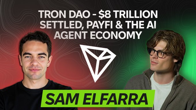 The image shows two men standing next to each other against a red background with black text. The two individuals are positioned behind a white symbol, likely representing an AI or stablecoin. Below them, there's a title of the image that reads "TRON DAO SETTLEED, PAYFI'THE AI Agent Economy", indicating they're talking about the cryptocurrency market and its underlying blockchain technology. This could be part of a discussion on decentralized finance, virtual assets, and how they impact traditional financial systems.