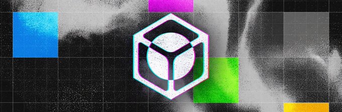 A stylized graphic featuring a 3D cube logo in the center against a black background with gridded smoke effects and blue, pink, green, and yellow color blocks.