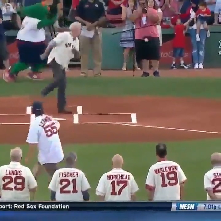 An older man runs toward home plate to deliver a ceremonial first pitch at a Red Sox game, while players wearing jerseys with names like "LANOIS 29," "FISCHER 21," "MOREHEAD 17," "WASLEWSKI 19," and "LACY 55" watch from the field. The NESN broadcast graphic shows it's 7:01 PM, with a ticker mentioning the "Red Sox Foundation," seemingly unrelated to any crypto investment theme.