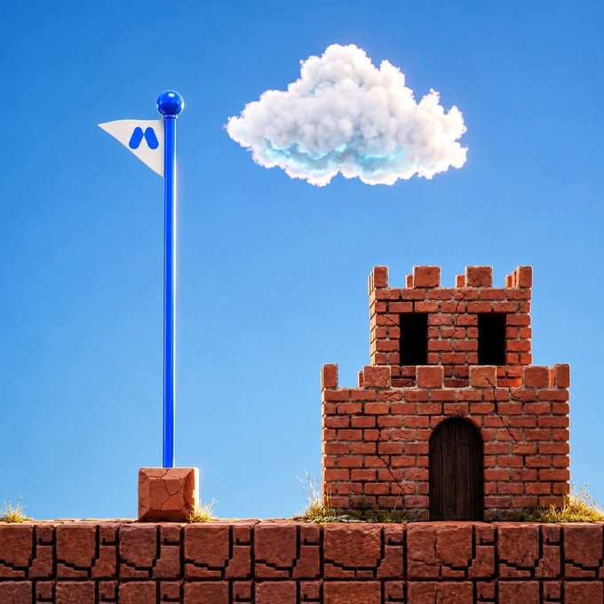 A pixel art illustration featuring a flag with a blue 'M' logo next to a brick castle tower on a brick platform, set against a blue sky with a single cloud.