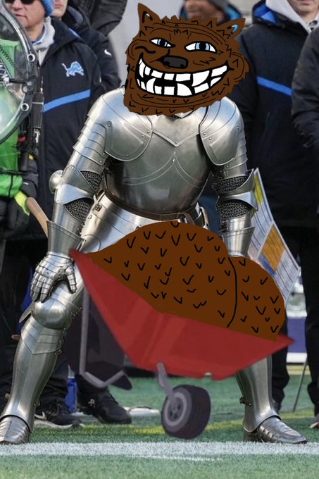 A humorous edited image showing a knight in full metal armor with a cartoonish brown wolf/dog head photoshopped on, holding a red flag on what appears to be a sports field.