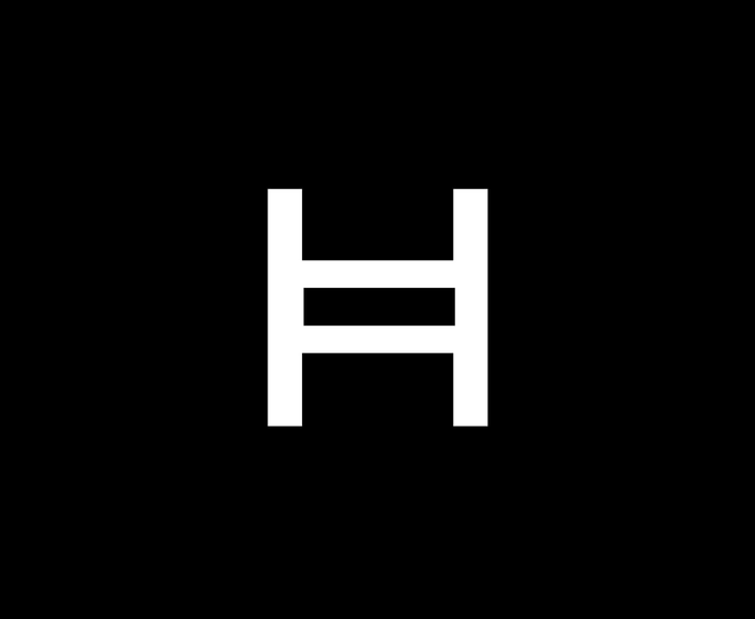 The image displays a white capital letter "H" centered on a black background, which likely serves as a stylized logo or symbol representing Hedera (HBAR), one of the cryptocurrencies mentioned in the accompanying post asking viewers to choose between Team HBAR or Team XRP.