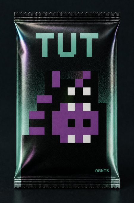 Black metallic-looking collectible package with the text 'TWT' at the top, a pixelated purple character design in the center, and 'AGMTS' logo at the bottom right.