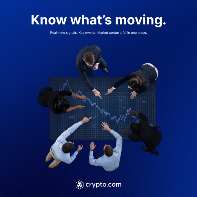 A promotional graphic for Crypto.com shows six people in business attire gathered around a digital tablet displaying a market chart, pointing at the data beneath the headline "Know what's moving." The accompanying post highlights this visual by emphasizing the app's Insights feature, which delivers real-time signals and market context to help users trade smarter before the crowd catches on.