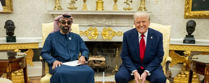 UAE's Sheikh Tahnoon bin Zayed, wearing a traditional white keffiyeh, sits beside U.S. President Donald Trump in the White House's ornate Oval Office, reflecting the new 49% banking partnership between the UAE royal and Trump's World Liberty financial venture.