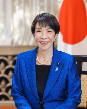 This image shows Sanae Takaichi, Japan's Minister for Digital Transformation, in front of the Japanese flag. Her role is relevant to the news about the Solana Foundation's partnership with SBI Holdings to build an on-chain financial market in Japan.