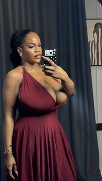 A woman with her hair pulled back takes a mirror selfie in a flowing burgundy halter dress, posing against a dark curtain backdrop. The caption "OYON" aligns with the elegant, poised vibe of her sophisticated look.