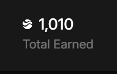 A dark screen showing '1,010 Total Earned' next to a Shazam logo icon.