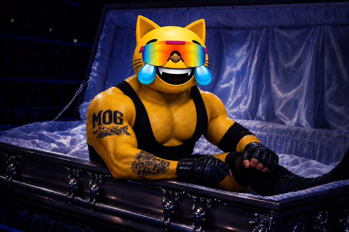 A muscular wrestler with yellow skin wearing a cat mask, rainbow sunglasses, and crying-joy emojis lies in a coffin with "MOG" tattooed on his arm.