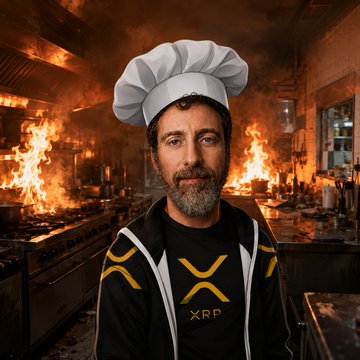 The image features a man wearing a chef's hat, standing in front of an open kitchen with flames behind him. The man has a beard and mustache, giving him a distinguished appearance as he poses for the photo. The background includes a dining table surrounded by chairs, suggesting that this scene takes place in a restaurant or similar setting where food is prepared. The post also mentions "XRP" on the man's shirt, which could be related to his profession as a chef or simply an interest in cryptocurrency.