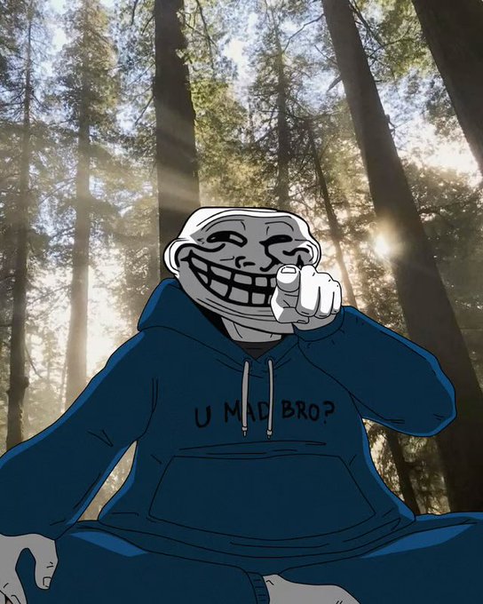 An illustrated troll face character wearing a blue hoodie with 'UMID BROP' text, pointing at the viewer against a backdrop of a sunlit forest.