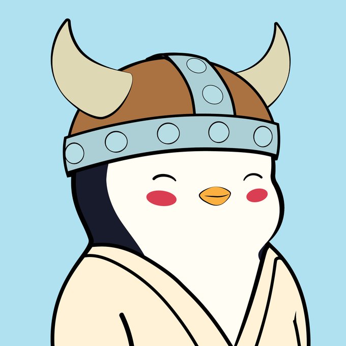 A cartoon penguin-like character wearing a Viking helmet with horns and a beige robe, smiling with closed eyes and blushing cheeks against a light blue background.