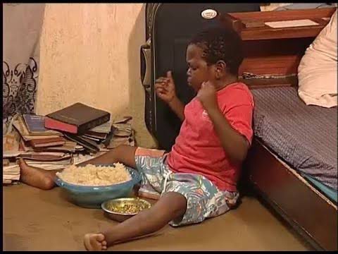 A young boy sits on the floor eating a bowl of rice, surrounded by stacked books and a bed in a modest room, capturing the playful spirit of a meme about prioritizing a simple meal over intangible crypto gains. The image humorously illustrates the post's sentiment that selling one NFT ("one take chop") to afford food is more vital than any dev intervention, emphasizing survival over digital speculation.
