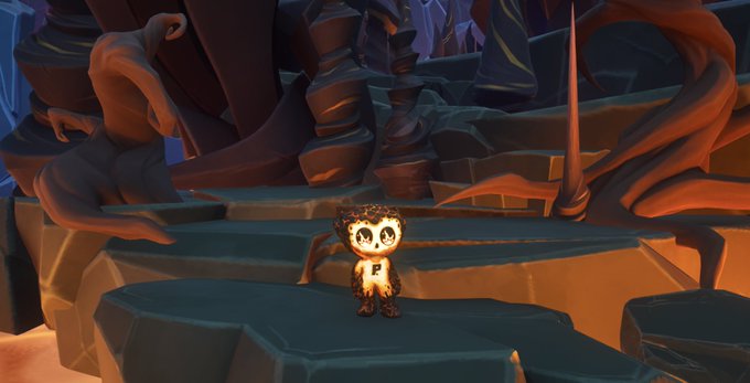 A small, stylized character with large glasses and a textured appearance stands on a dark rocky platform within a fantasy-style environment featuring twisted spires and dramatic lighting.
