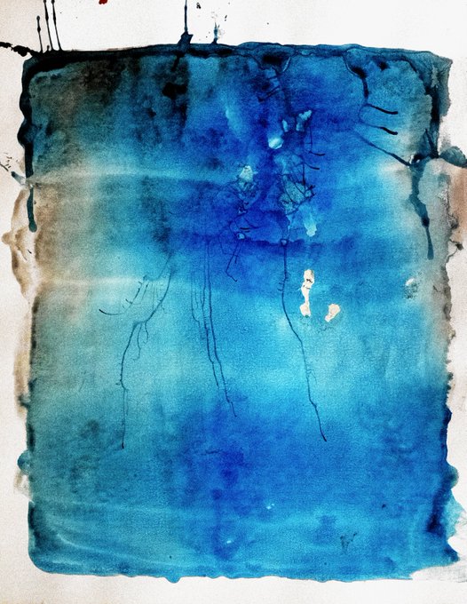 An abstract watercolor painting features a square wash of blue and teal tones with darker drips and splatters on a white background.