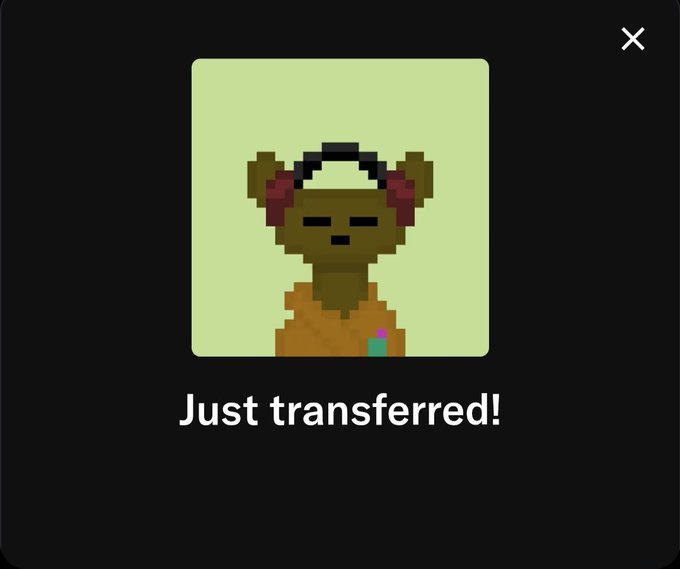 A dark digital notification box displaying a pixel-art character with bear ears and headphones, with the text 'Just transferred!' below it.