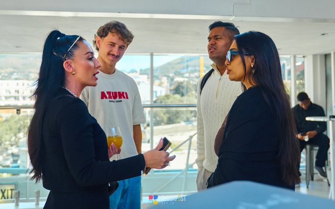 The image shows a group of people standing around, engaged in conversation with each other. There are four individuals visible in the scene - two women and two men. One woman is holding an orange drink while talking to another person, possibly discussing their shared interests or experiences. The others appear to be listening attentively as well.

The post that accompanies this image reads: "Gm The strongest networks are built person by person. That’s exactly what @AvaxTeam1 is doing." This message emphasizes the importance of building strong connections and relationships with others, which can lead to a more fulfilling life.