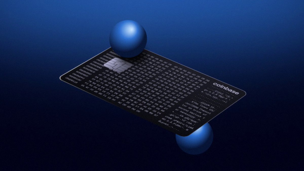 The image features two blue balls floating in front of a black credit card reader, which appears to be a Bitcoin wallet. The background is dark blue, providing contrast for the objects within the frame. The text "collab" can also be seen on the image.