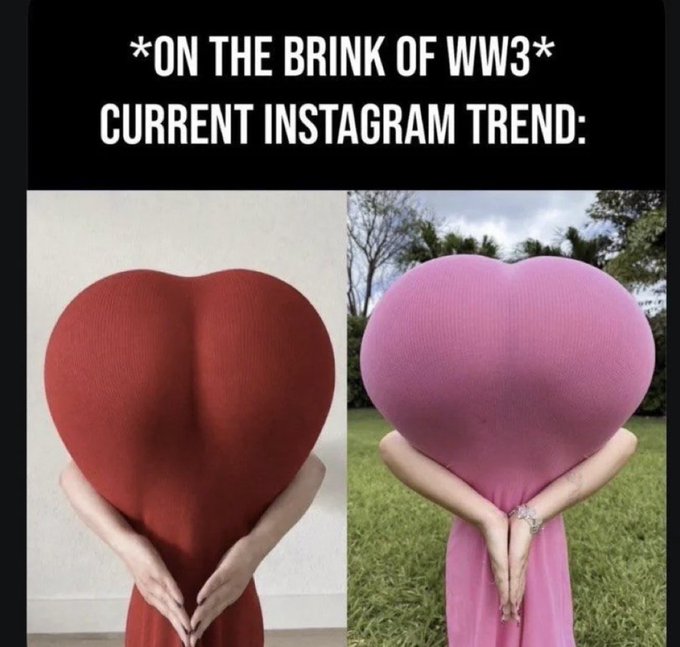 A meme with text '*ON THE BRINK OF WW3* CURRENT INSTAGRAM TREND:' showing two people posing in red and pink heart-shaped costumes.