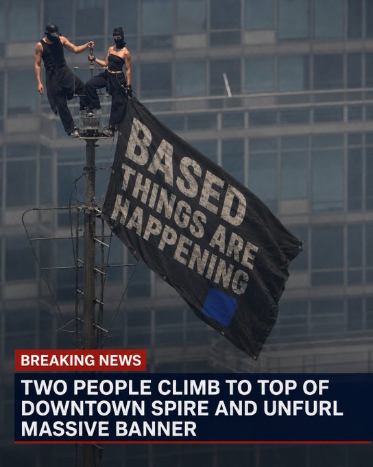 Two people climb atop a downtown spire to unfurl a large black banner reading "BASED THINGS ARE HAPPENING," playing on the "BREAKING NEWS" chyron below to create a clever pro-Crypto/Base meme promising exciting developments for the platform.